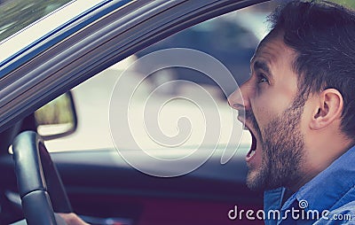 Side profile angry driver. Negative human emotions face expression Stock Photo