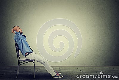 Side profile business man relaxes in his empty office Stock Photo