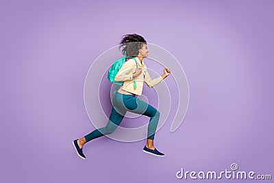 Side profile full length body size photo of cheerful positive running jumping girl wearing pants trousers yellow shirt Stock Photo