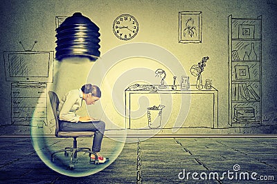 Side profile young woman using working on computer sitting inside electric lamp Stock Photo
