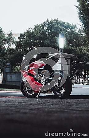 Side shot of a red motorcycle Ducati Panigale 1199, parked on the street Editorial Stock Photo