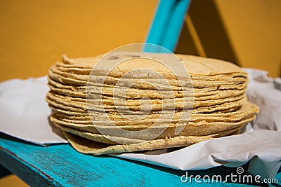 Side shot of Stack of fresh corn tortillas on paper - close up Stock Photo