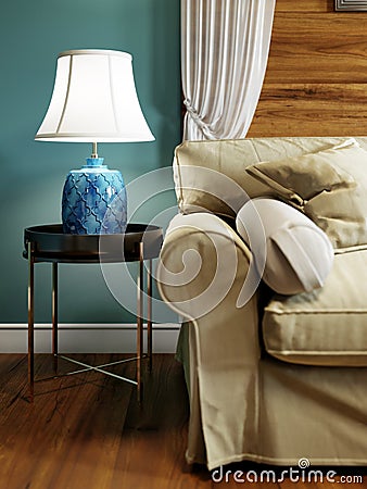 Side table with blue table lamp near the sofa. Metal legs, black countertop Stock Photo