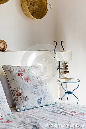 Bedside table with white lamp in the bedroom with vintage decor Stock Photo