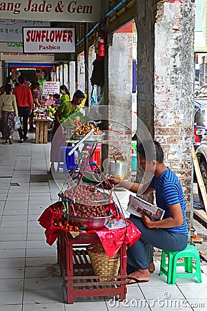 Side Vendor selling fruits & pickled product along the outdoor corridor of Bogyoke Market Editorial Stock Photo