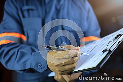 Side view, an auditor or specter holding a clipboard and checklist Stock Photo
