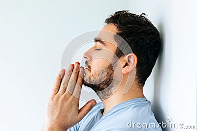 side view of a bearded man going through difficult period in life, praying. Stock Photo