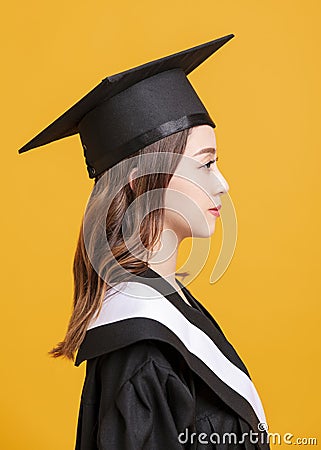 Side view beautiful young woman in graduation gowns Stock Photo