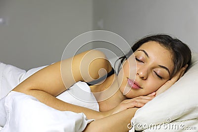 Side view of beautiful young woman sleeping in her bed at home Stock Photo