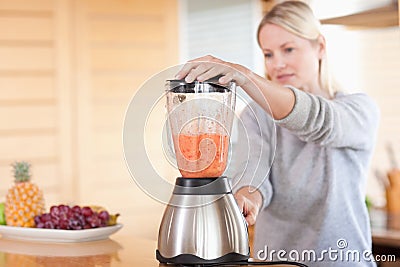 Side view of blender chopping fruits Stock Photo