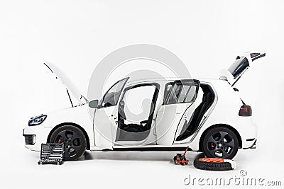 side view of broken white car with open doors and open hood Stock Photo