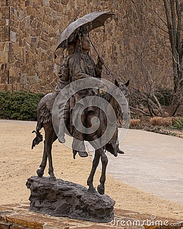 Side view of a bronze sculpture titled `Honeymoon at Crow Fair` by John Coleman in Edmond, Oklahoma. Editorial Stock Photo