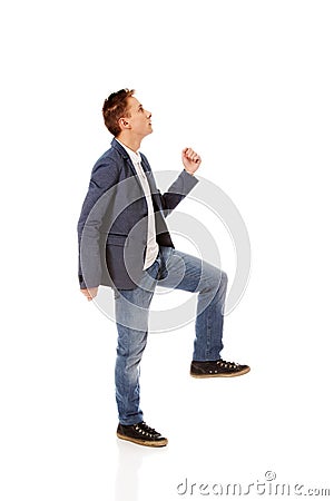 Side view of a businessman climbs the stairs Stock Photo