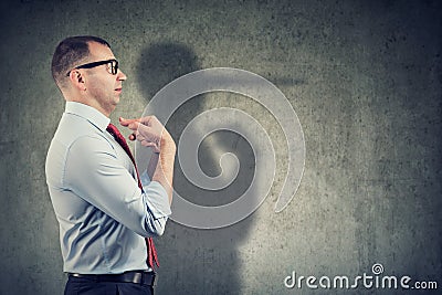 Side view of a businessman looking surprised when being caught on lie Stock Photo