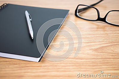 Side view of a pen and notebook at the ready on the table. Close up. Stock Photo