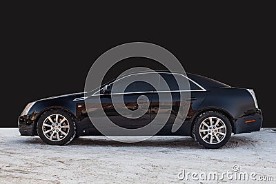 Side view of Cadillac CTS in black color after cleaning before sale in a winter day background on parking above black wall Editorial Stock Photo