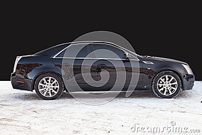 Side view of Cadillac CTS in black color after cleaning before sale in a winter day background on parking above black wall Editorial Stock Photo