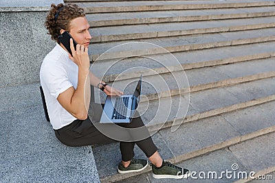 Side view of Calm curly business man with briefcase Stock Photo