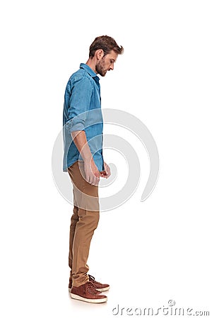 Side view of a casual man looking down at something Stock Photo