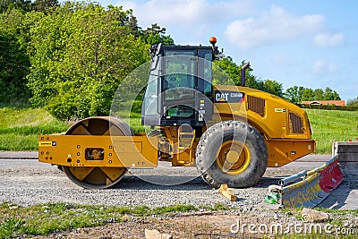 Side view of a Caterpillar CS66B vibratory soil compactor.. Editorial Stock Photo