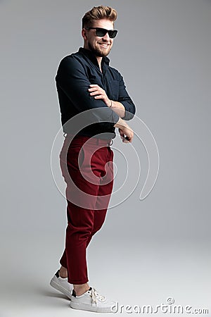 Side view of a cheerful fashion man fixing his sleeve Stock Photo