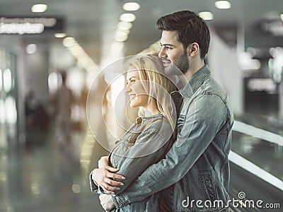 Beaming man embracing outgoing female Stock Photo