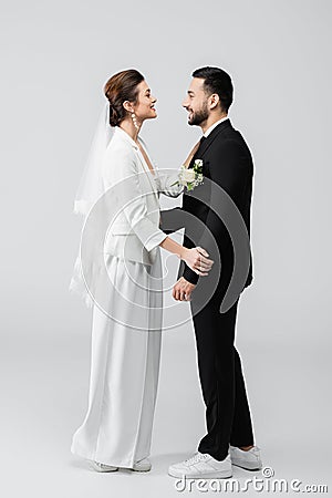 Side view of cheerful multiethnic newlyweds Stock Photo