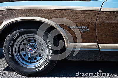 Side view of classic long station wagon with wood-veneered doors, it's a blue Ford Gran Torino. Editorial Stock Photo