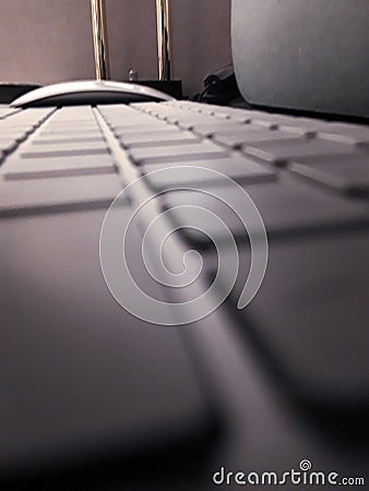 Side View closeup of Keyboard & mouse with Shallow Depth of field with mouse in focus Stock Photo