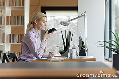 Side view confident businesswoman recording audio voice message on phone Stock Photo