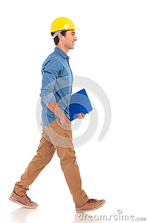 Side view of a construction engineering student walking with cl Stock Photo