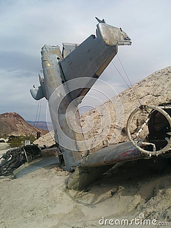 Side view of crashed plane on small desert hill Stock Photo