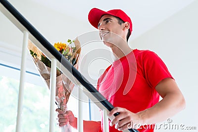 Delivery man holding flower bouquet gift Stock Photo