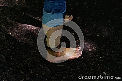 Side view of dirty female legs in jeans Stock Photo