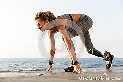 Side view of disabled athlete woman with prosthetic leg Stock Photo