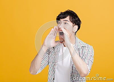 Side view of excited young man screaming loudly Stock Photo