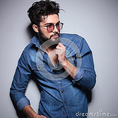 Side view of a fashion man pulling his colar Stock Photo