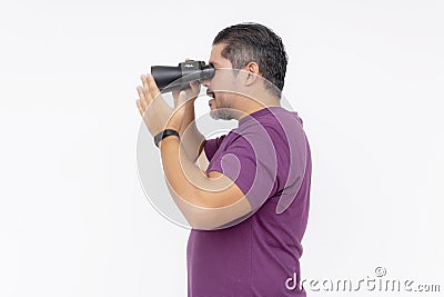 Side view of a focused man holding binoculars, searching or observing, isolated on a white background Stock Photo