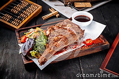 Grilled juicy cowboy steak with salad Stock Photo