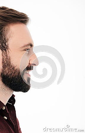 Side view half face portrait of a smiling bearded man Stock Photo