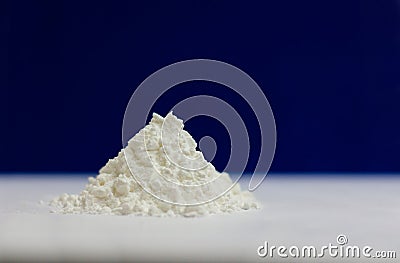 Side view of heap of white modified starch isolated on blue and gray background Stock Photo