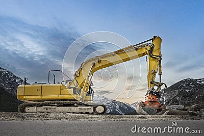 Side view of a heavy yellow grab excavator with grapple Stock Photo