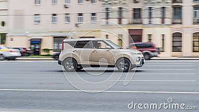 Side view of Kia Soul car in motion. Beige compact hatchback moving on the street on high speed Editorial Stock Photo