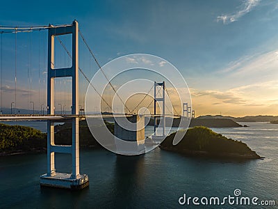 Side view of Kurushima bridge leading to Imabari as sun sets Stock Photo