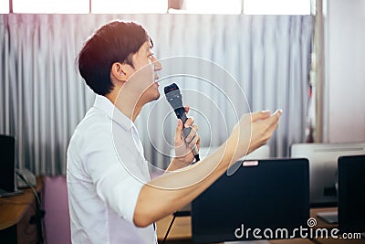 Side view of businessman speaking and making a lecture in public speaking event in the room Stock Photo