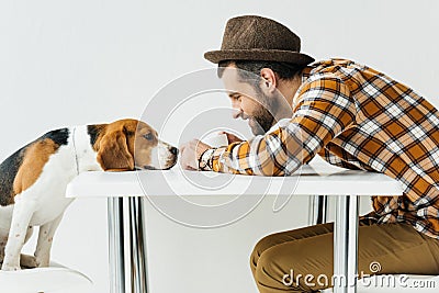 side view of man touching dog nose Stock Photo