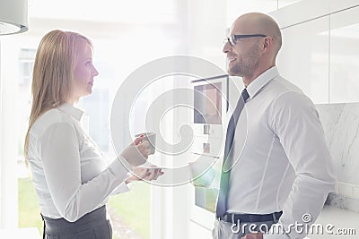 Side view of mid adult business couple talking at home Stock Photo