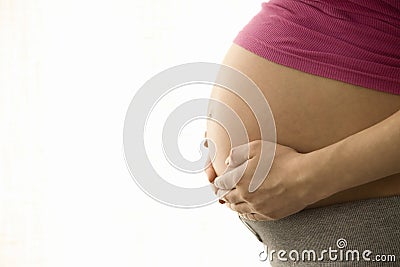 Side View Midsection Of Pregnant Woman With Hands Holding Tummy Stock Photo