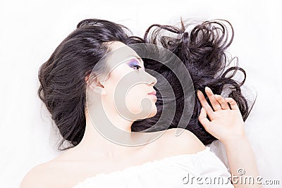 Side view of model portrait with black hair over white Stock Photo