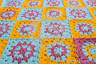 Side view of multicolored crochet granny squares, seamed together in a blanket Stock Photo